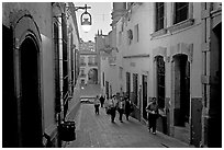 Children heading to school up a narrow cajaon, dawn. Zacatecas, Mexico (black and white)