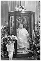 Figure of Santo Nino Del Milagro with offered flowers. Zacatecas, Mexico (black and white)