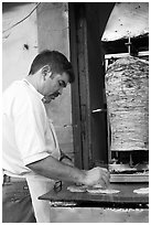 Man preparing tacos with meat. Guanajuato, Mexico (black and white)