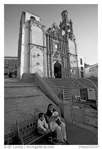 Woman and child waiting for bus below a church. Guanajuato, Mexico