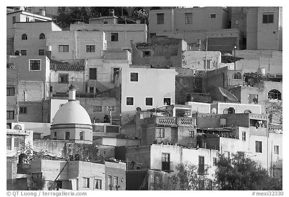 Multicolored houses on a steep hillside, late afternoon. Guanajuato, Mexico