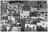 Multicolored houses on a steep hillside, late afternoon. Guanajuato, Mexico (black and white)