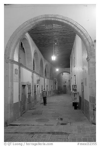 Man walking in an arched passage a dawn. Guanajuato, Mexico