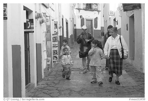 Family walking down an alley. Guanajuato, Mexico