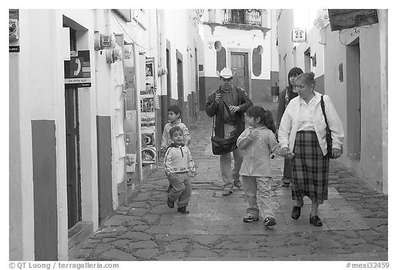 Family walking down an alley. Guanajuato, Mexico