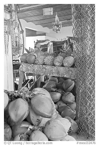 Tropical Fruit stand with girl in background. Mexico