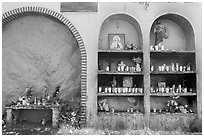 The exterior wall of a roadside chapel. Mexico (black and white)