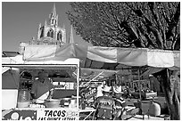 Taco stand on town plaza with cathedral in background. Mexico (black and white)