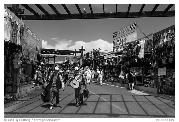 Musicians walking in flee market, La Bufadora. Baja California, Mexico (black and white)