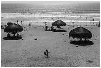 Straw sun shelter umbrellas and ocean, Ensenada. Baja California, Mexico (black and white)