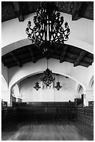 Ballroom and intricate ironwork in heavy chandeliers, Riviera Del Pacifico, Ensenada. Baja California, Mexico (black and white)