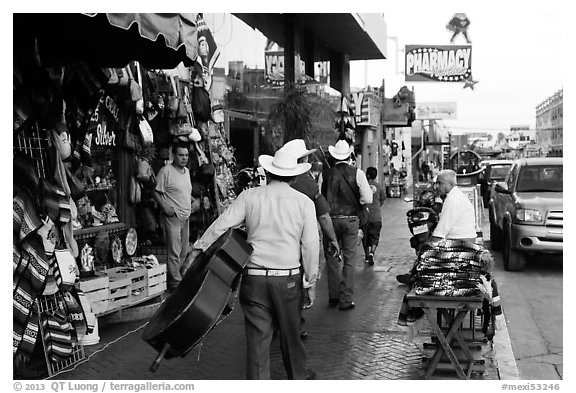 Musicians walking on street, Ensenada. Baja California, Mexico