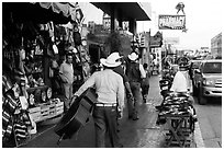 Musicians walking on street, Ensenada. Baja California, Mexico (black and white)