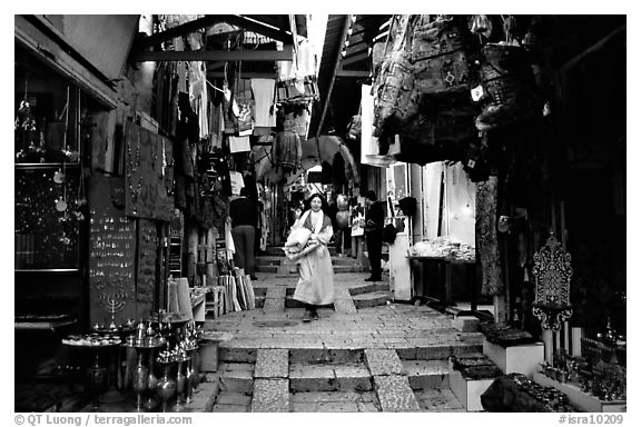 Narrow alley lined with shops. Jerusalem, Israel (black and white)