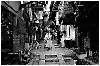 Narrow alley lined with shops. Jerusalem, Israel (black and white)