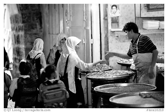 Muslem women purchasing sweets. Jerusalem, Israel (black and white)