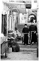 Two christian monks in a narrow alley. Jerusalem, Israel (black and white)