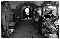 Fruit and vegetable store in an old town archway. Jerusalem, Israel (black and white)