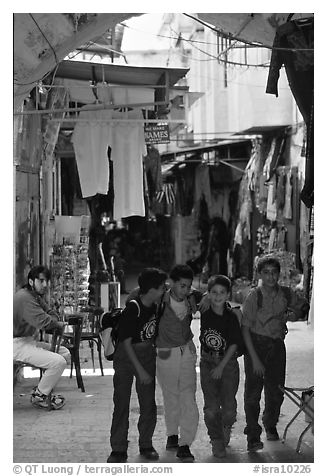 Children in a busy old town alley. Jerusalem, Israel (black and white)