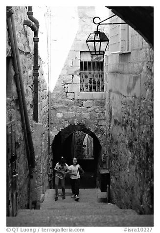 Children on stairs of an old alley. Jerusalem, Israel (black and white)