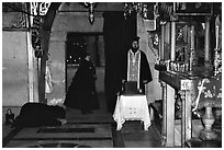 Worshiping inside the Church of the Holy Sepulchre. Jerusalem, Israel ( black and white)