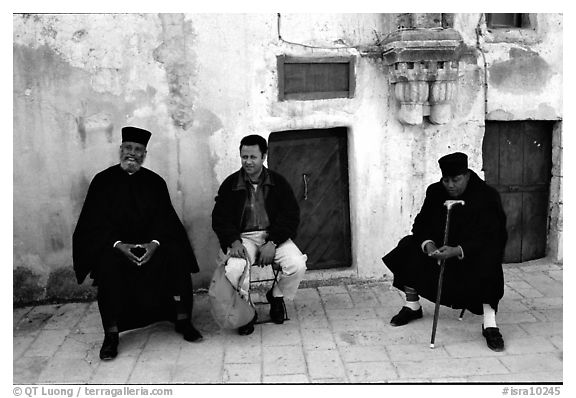 Copt monks and pilgrim in the Ethiopian Monastery. Jerusalem, Israel (black and white)