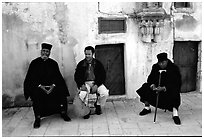 Copt monks and pilgrim in the Ethiopian Monastery. Jerusalem, Israel (black and white)
