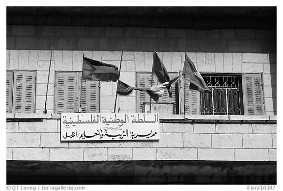 Palestinian flags and inscriptions in arabic in front of a school, East Jerusalem. Jerusalem, Israel (black and white)