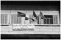 Palestinian flags and inscriptions in arabic in front of a school, East Jerusalem. Jerusalem, Israel ( black and white)