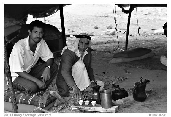 Bedouin men offering tea in a tent, Judean Desert. West Bank, Occupied Territories (Israel) (black and white)
