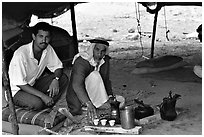 Bedouin men offering tea in a tent, Judean Desert. West Bank, Occupied Territories (Israel) (black and white)