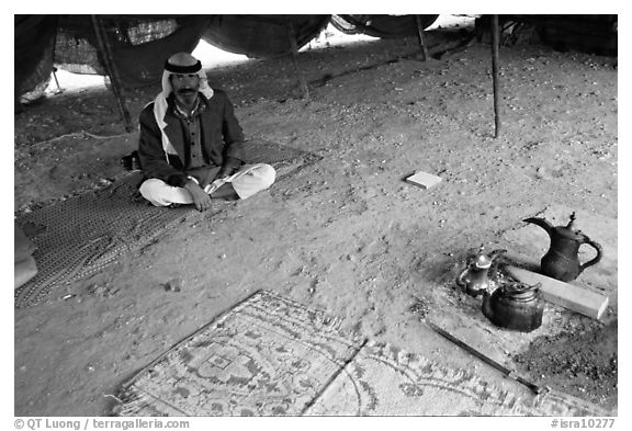 Bedouin man sitting on a carpet in a tent, Judean Desert. West Bank, Occupied Territories (Israel)