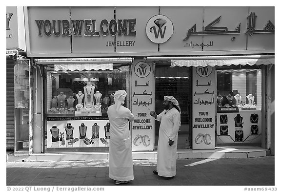 Men in front of jewellery, Gold Souk, Deira. United Arab Emirates (black and white)