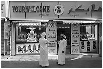 Men in front of jewellery, Gold Souk, Deira. United Arab Emirates ( black and white)