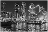 Restaurant boats and Al Rahim Mosque at night. United Arab Emirates ( black and white)