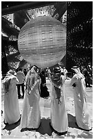 Men in kandura at light show, Saudi Arabia Pavilion. Expo 2020, Dubai, United Arab Emirates ( black and white)