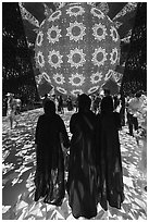 Women in abaya at light show, Saudi Arabia Pavilion. Expo 2020, Dubai, United Arab Emirates ( black and white)