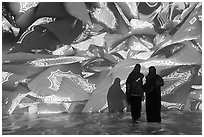 Women interacting with light show, Pakistan Pavilion. Expo 2020, Dubai, United Arab Emirates ( black and white)
