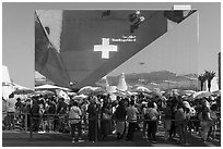 Visitors with umbrellas and reflection, Swizerland Pavilion. Expo 2020, Dubai, United Arab Emirates ( black and white)