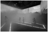Visitors walk in Swizerland Pavilion fog. Expo 2020, Dubai, United Arab Emirates ( black and white)