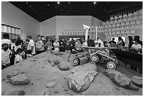Visitors looking at Mars rover exhibit, USA Pavilion. Expo 2020, Dubai, United Arab Emirates ( black and white)