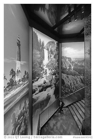 Woman below huge photographic prints, USA Pavilion. Expo 2020, Dubai, United Arab Emirates (black and white)