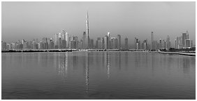 Downtown Dubai skyline with reflections in Dubai Creek. United Arab Emirates (Panoramic black and white)