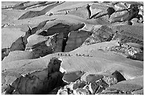 Party crosses a snow bridge in the upper Vallee Blanche in summer, Mont-Blanc range, Alps, France. (black and white)