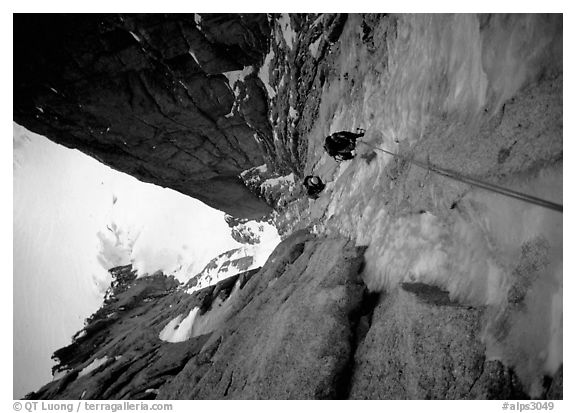 Climbers Frank and Alain climb thin ice in the Super-Couloir on Mt Blanc du Tacul, Mont-Blanc Range, Alps, France.