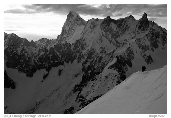 Alpinists go down Aiguille du Midi on a sharp ridge. Alps, France