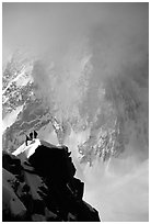 Alpinists on a buttress of Aiguille du Midi climbing the Cosmiques ridge. Alps, France (black and white)