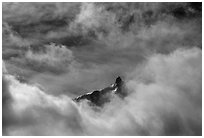 Aiguille du Midi summit emerges from the clouds. Alps, France (black and white)