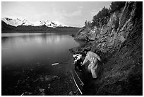 Kayaker pulling on shore at midnight, Muir Inlet. Glacier Bay National Park, Alaska (black and white)