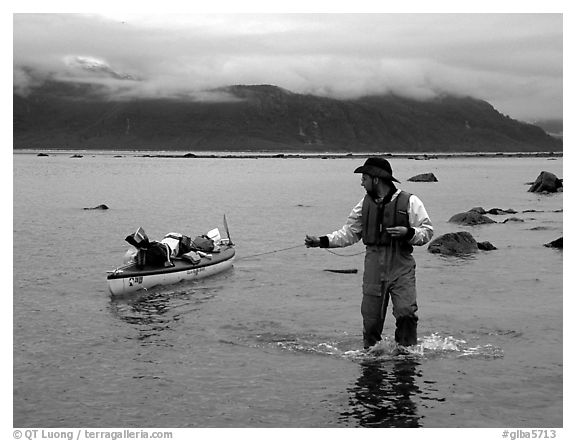 Kayaker tows kayak near Scidmore Bay. Glacier Bay National Park, Alaska